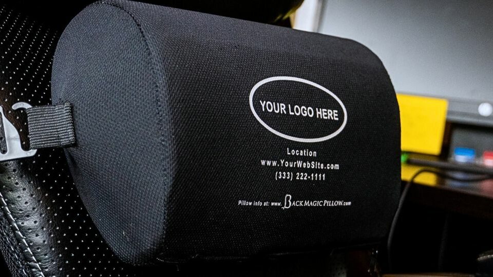 Custom branded Back Magic Pillow on a car seat